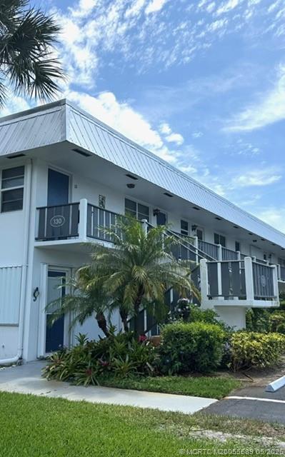 2929 Southeast Ocean Boulevard, Unit 1306 Stuart, FL 34996 - Photo 16 of 17 a front view of a house with a garden