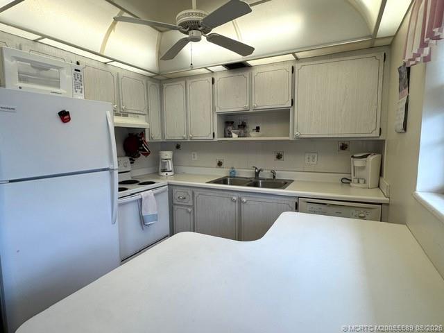 2929 Southeast Ocean Boulevard, Unit 1306 Stuart, FL 34996 - Photo 2 of 17 a kitchen with stainless steel appliances a refrigerator sink and cabinets