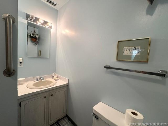 2929 Southeast Ocean Boulevard, Unit 1306 Stuart, FL 34996 - Photo 9 of 17 a bathroom with a toilet sink and mirror