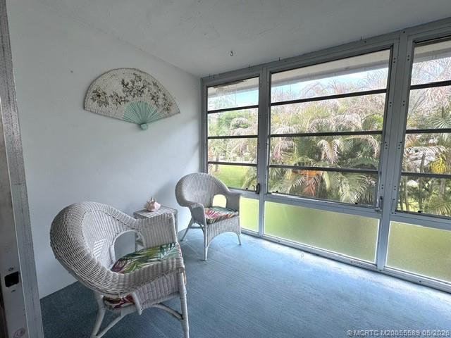 2929 Southeast Ocean Boulevard, Unit 1306 Stuart, FL 34996 - Photo 10 of 17 a living room with furniture and a large window