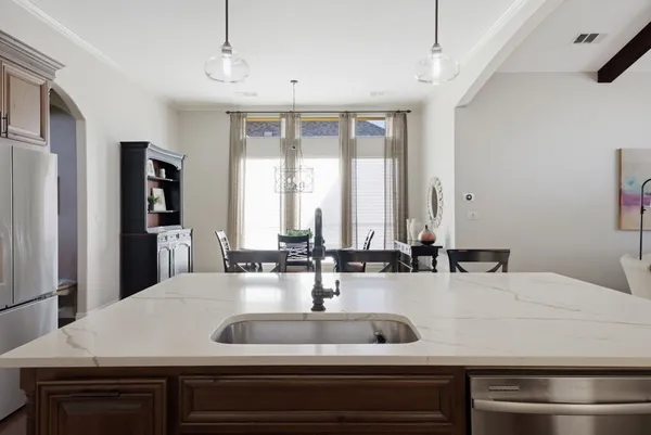 a view with granite countertop a sink and a window