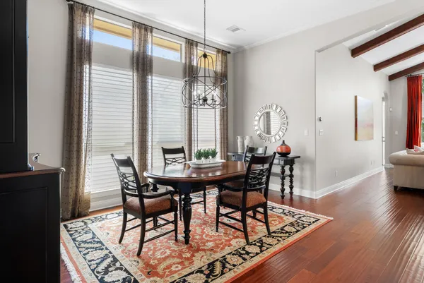 a view of a dining room with furniture and wooden floor