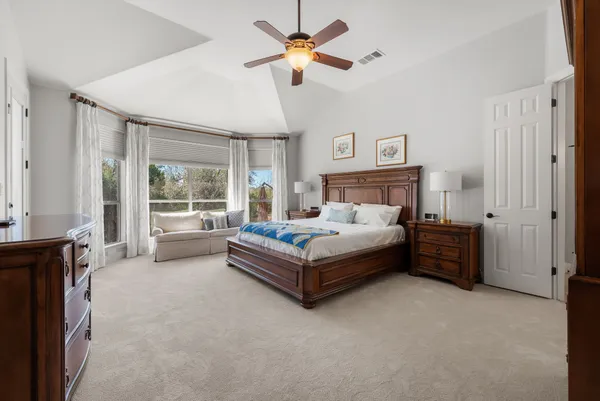 a bed room with a bed and a chandelier
