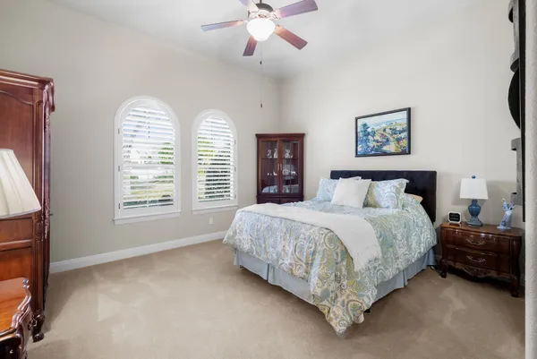 a spacious bedroom with a bed and a window