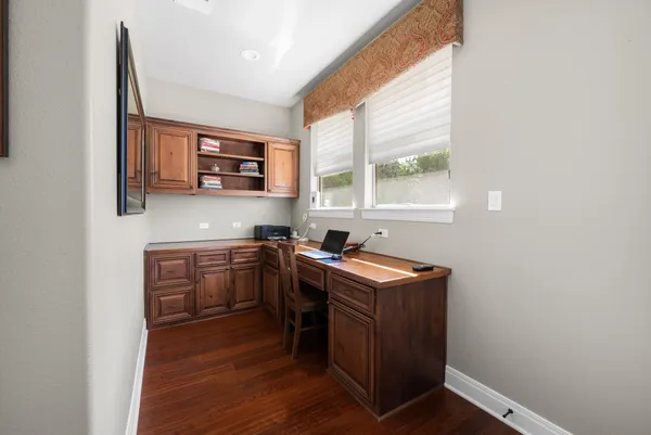 a kitchen with stainless steel appliances granite countertop a sink a stove and a wooden floors