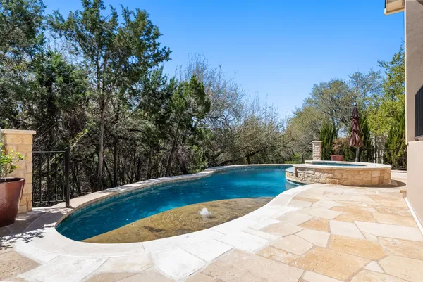 a view of a swimming pool with a yard