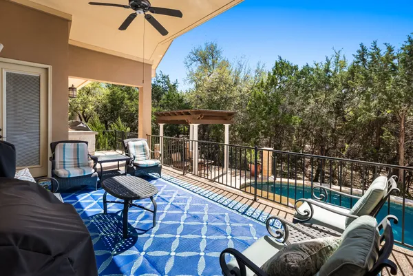 a view of a patio with a dining table and chairs with wooden floor