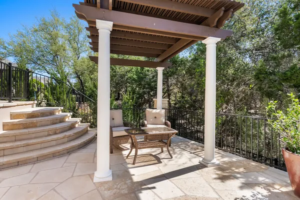 a view of a patio with a table chairs and a backyard