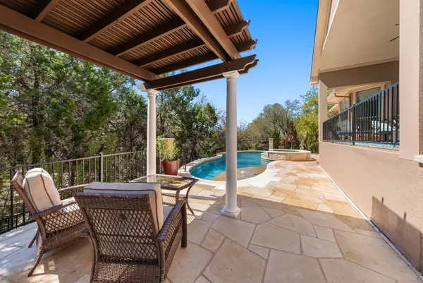a view of a patio with a table chairs and a backyard