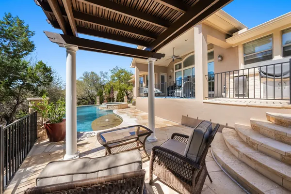 a view of a patio with a dining table and chairs with wooden floor and fence