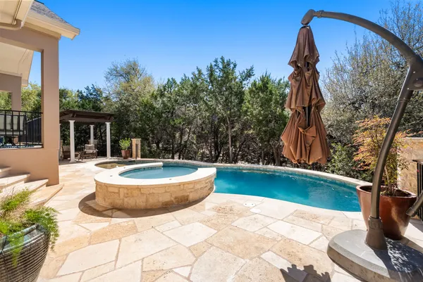 a swimming pool with barbeque oven and seating space