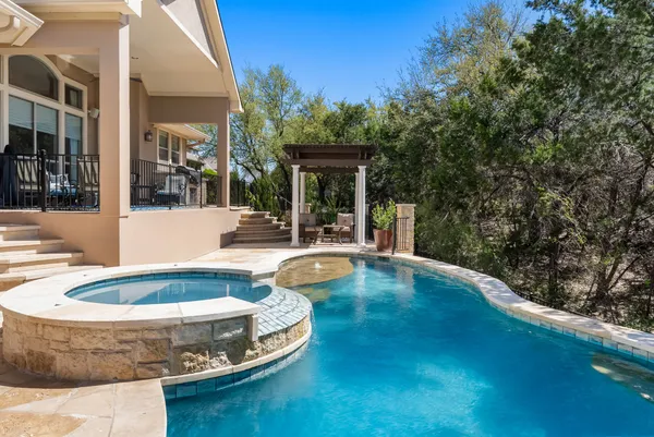 a view of a house with swimming pool and sitting area