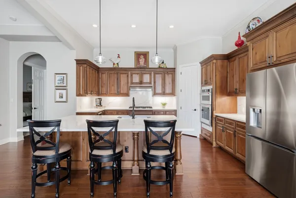 a kitchen with a table chairs refrigerator and cabinets