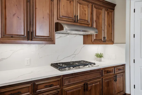 a stove top oven sitting inside of a kitchen