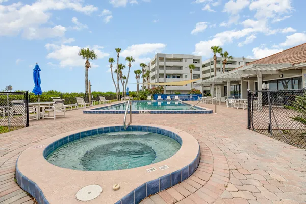 a view of a swimming pool with outdoor seating