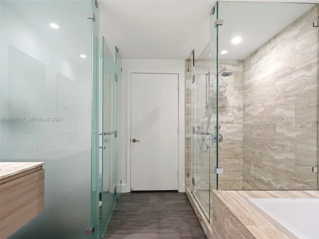 a bathroom with a glass shower door