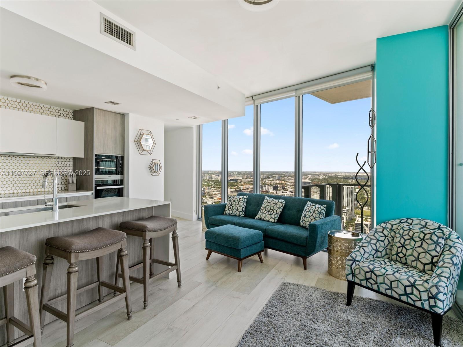 2900 Northeast 7th Avenue, Unit 4301 Miami, FL 33137 - Photo 2 of 24 a living room with furniture and a large window