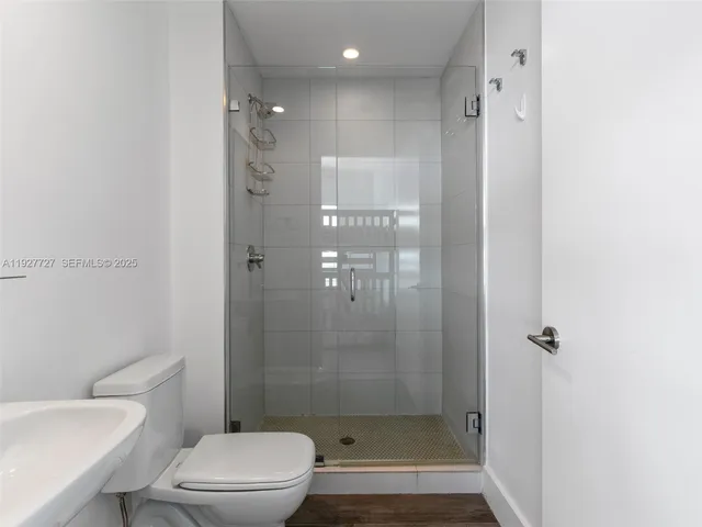 a bathroom with a shower a toilet and sink