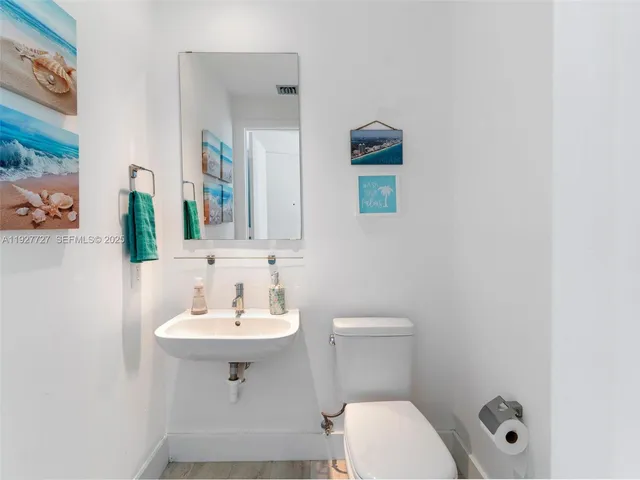 a bathroom with a sink a toilet and mirror