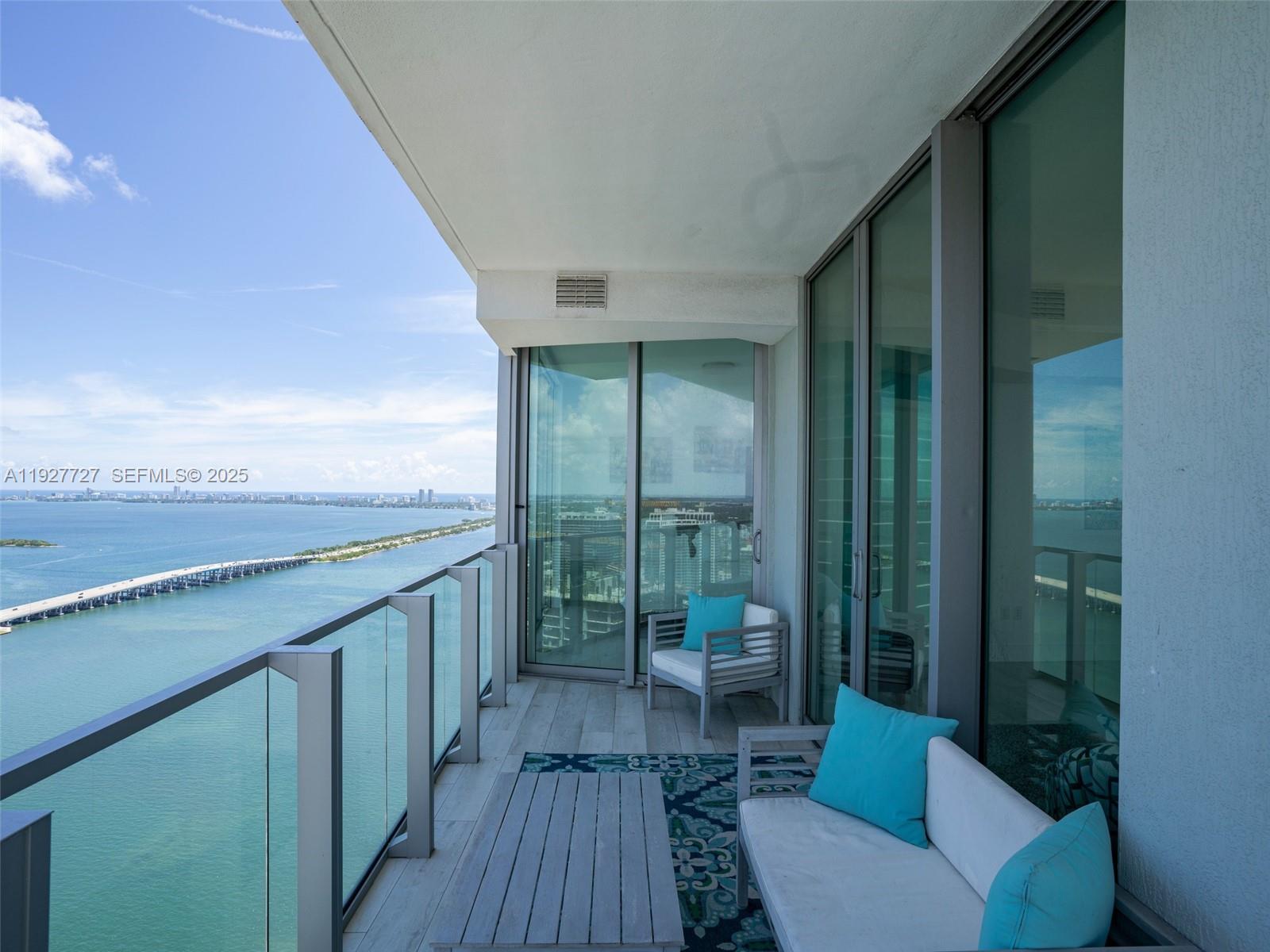 2900 Northeast 7th Avenue, Unit 4301 Miami, FL 33137 - Photo 24 of 24 a bathroom with a granite countertop sink a toilet a mirror and shower