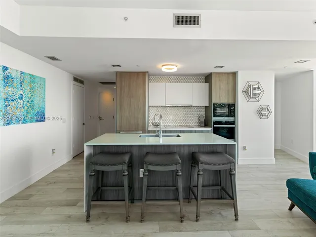 a kitchen with a table and chairs in it