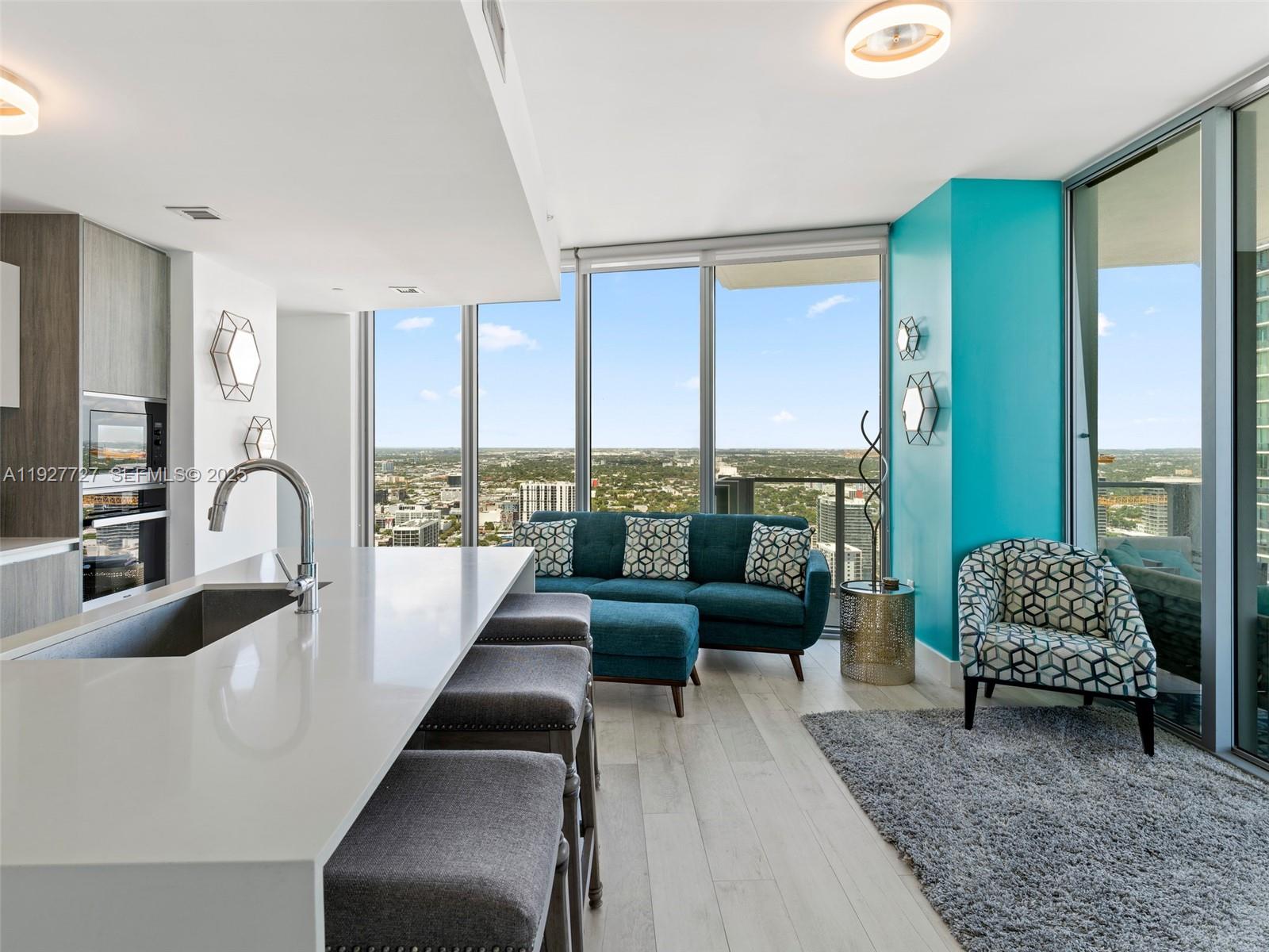 2900 Northeast 7th Avenue, Unit 4301 Miami, FL 33137 - Photo 4 of 24 a living room with furniture and a large window