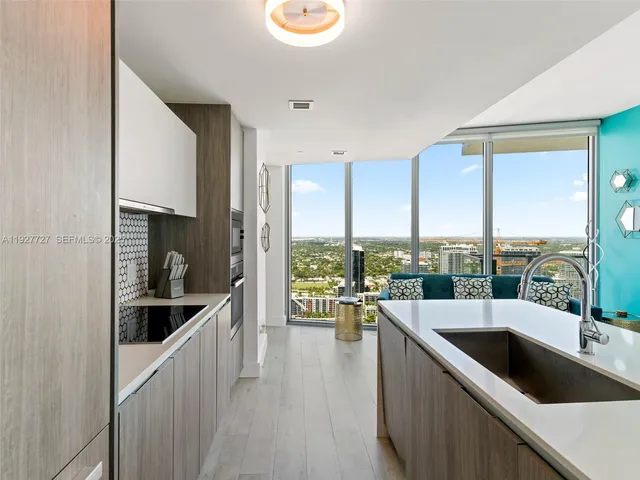 a kitchen with a large window and a sink