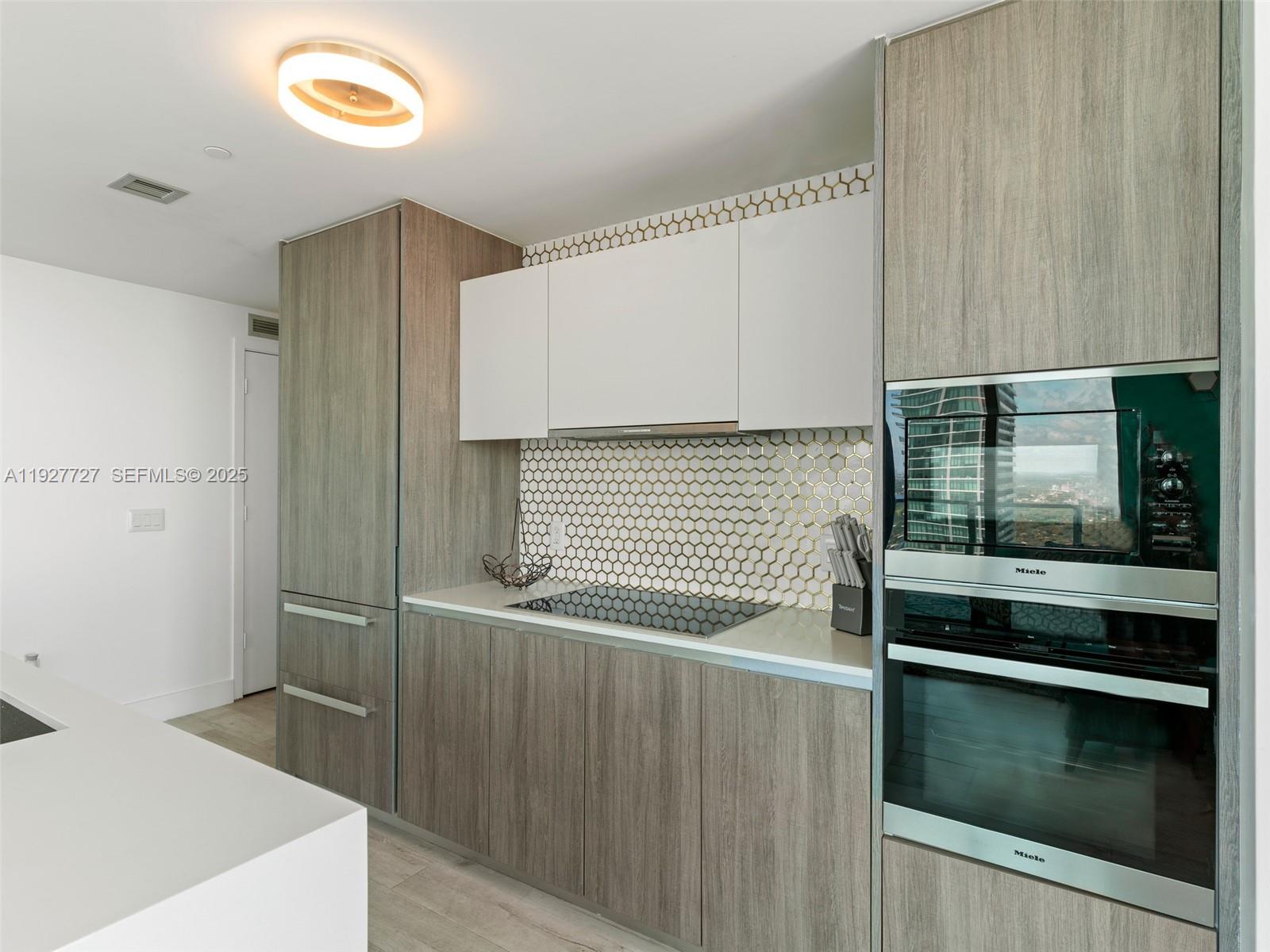 2900 Northeast 7th Avenue, Unit 4301 Miami, FL 33137 - Photo 8 of 24 a bathroom with a sink and a mirror