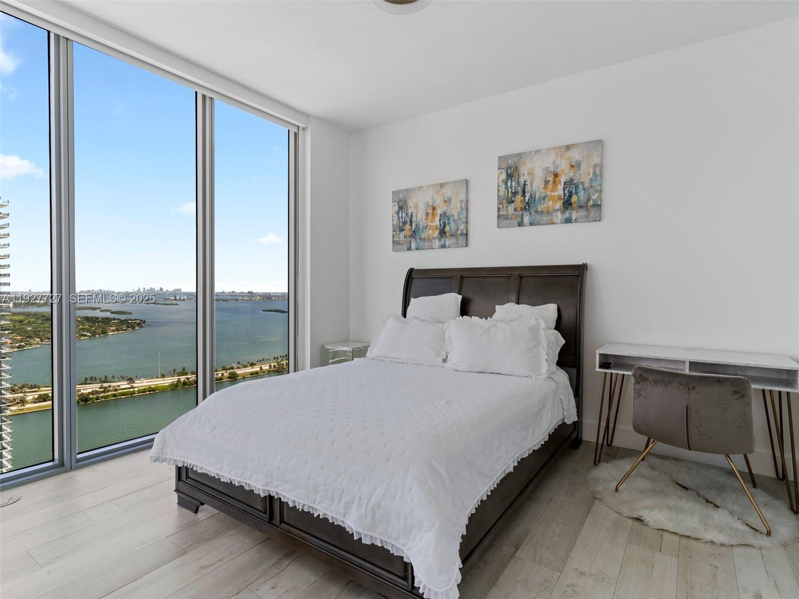 2900 Northeast 7th Avenue, Unit 4301 Miami, FL 33137 - Photo 10 of 24 a large bed sitting in a bedroom next to a window