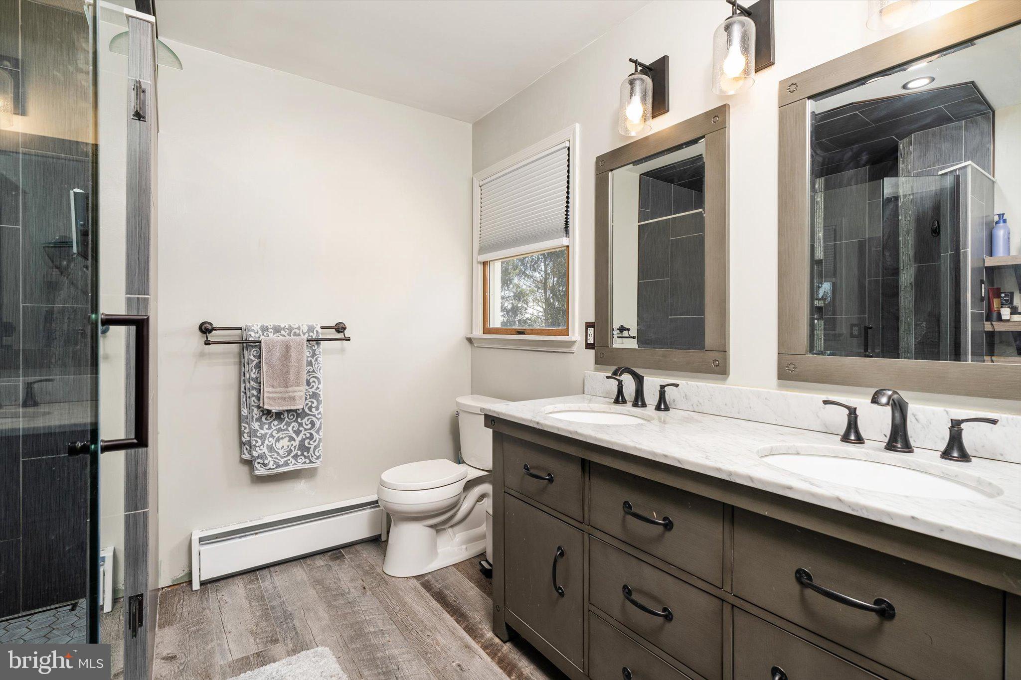 756 Province Line Road Allentown, NJ 08501 - Photo 26 of 41 a bathroom with a granite countertop sink a toilet a mirror and shower