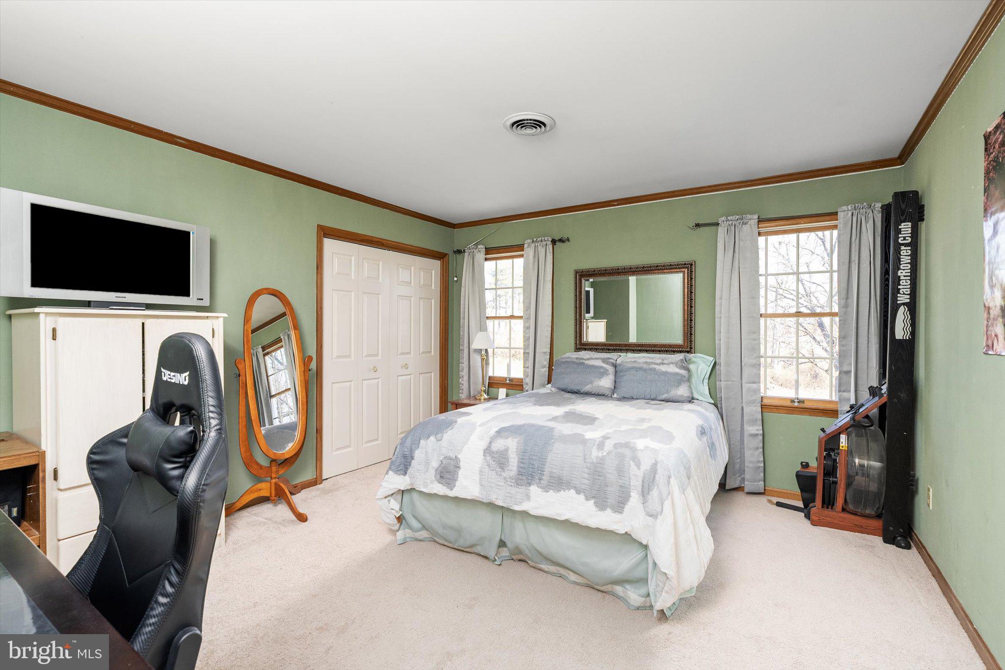 756 Province Line Road Allentown, NJ 08501 - Photo 32 of 41 a bedroom with bed a flat tv screen and chair