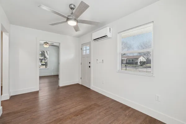 wooden floor in an empty room with a window