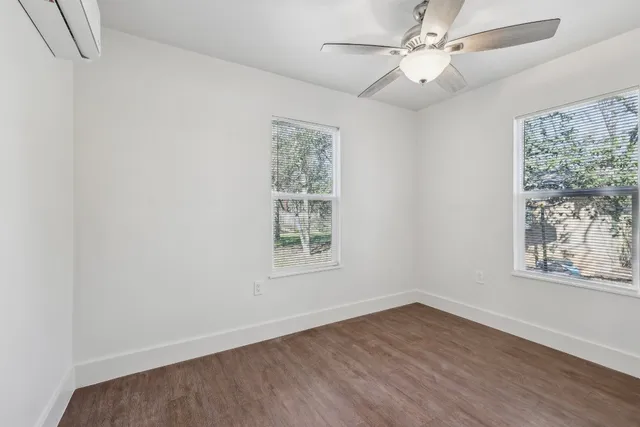 wooden floor in an empty room with a window