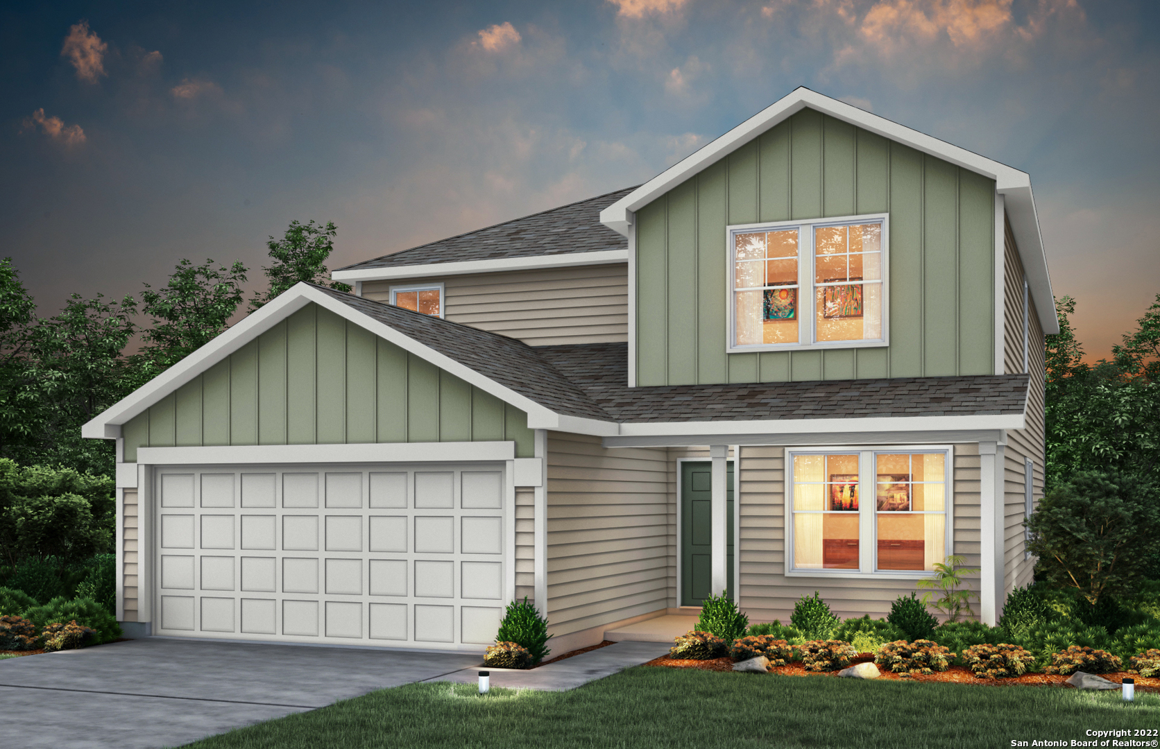 a front view of a house with a yard and garage