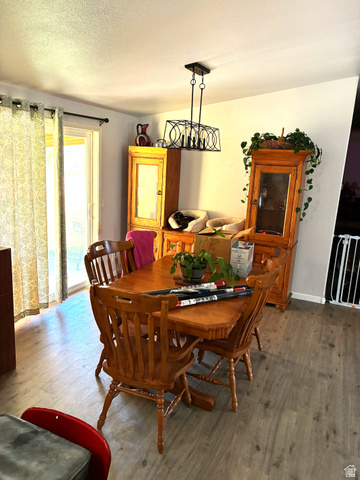 547 East 2000th Street North Vernal, UT 84078 - Photo 10 of 50 Dining area featuring wood-finish flooring and a rectangular chandelier with a matte black finish