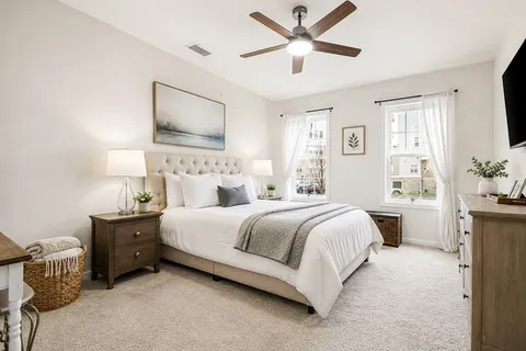 a bedroom with a large bed and a chandelier