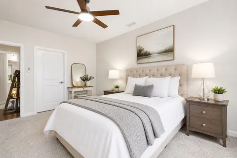 a bedroom with a bed and a chandelier