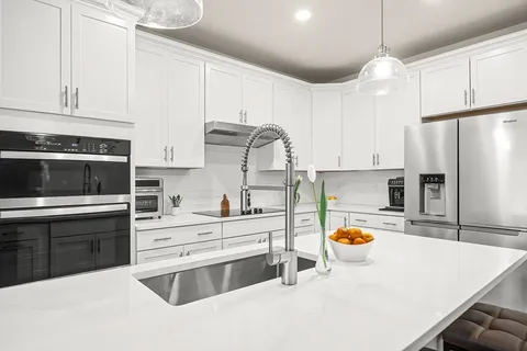 a kitchen with a white stove top oven and refrigerator