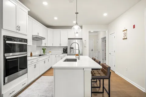 a kitchen with a sink stove and microwave