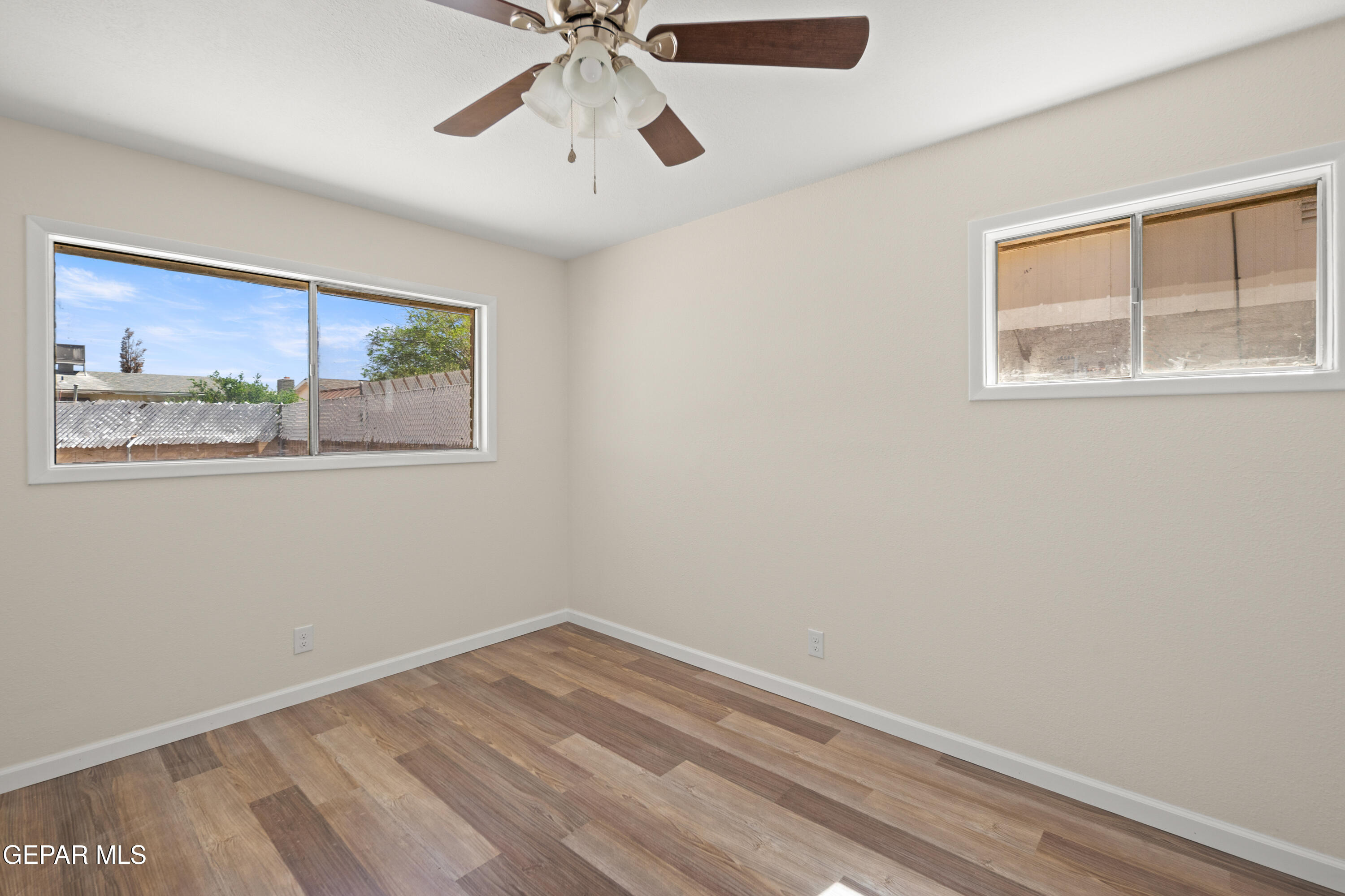 9220 Raleigh Drive El Paso, TX 79924 - Photo 14 of 23 a view of empty room with wooden floor and fan