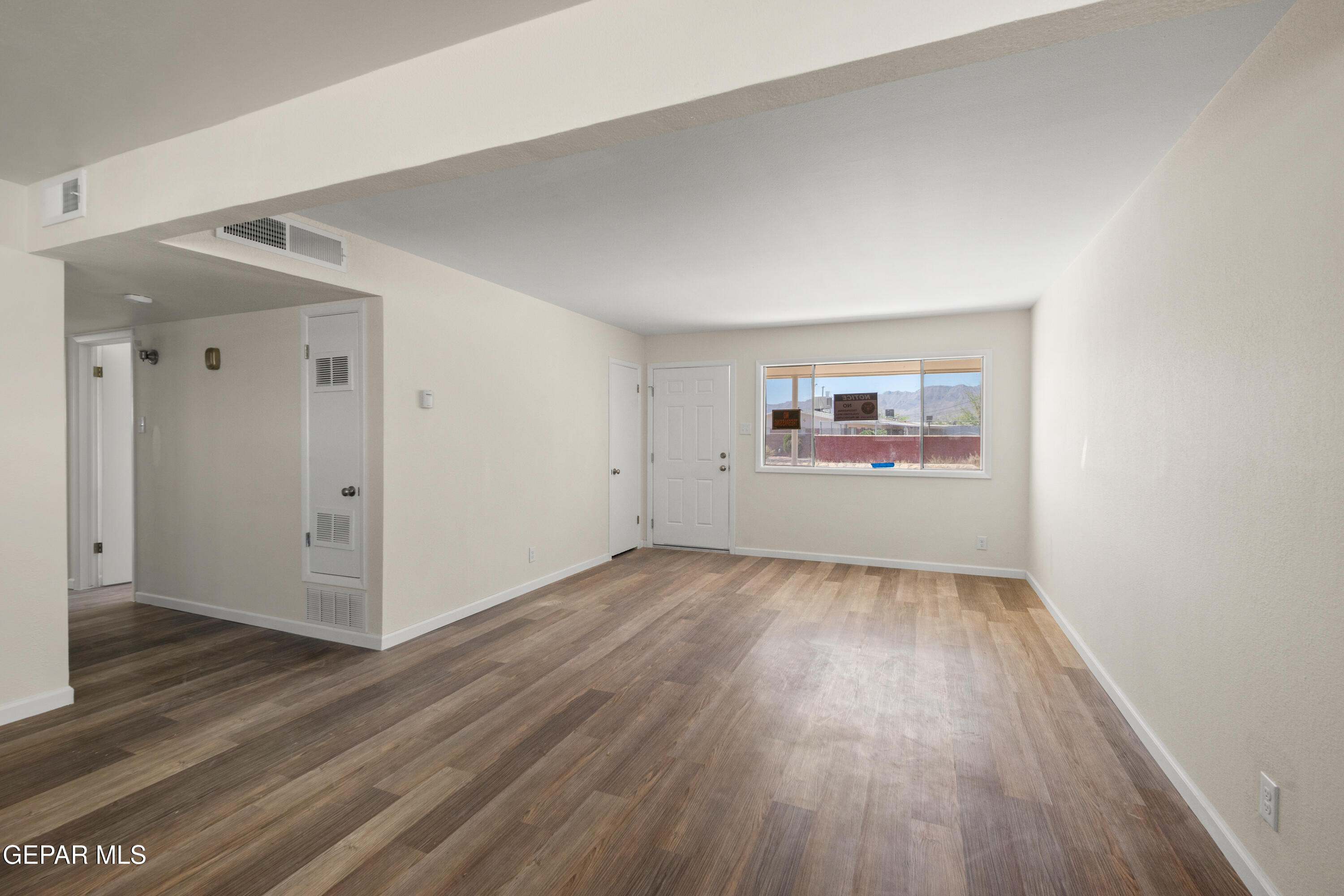 9220 Raleigh Drive El Paso, TX 79924 - Photo 6 of 23 an empty room with wooden floor and windows
