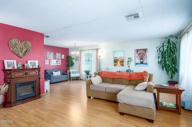 a living room with furniture and a fireplace