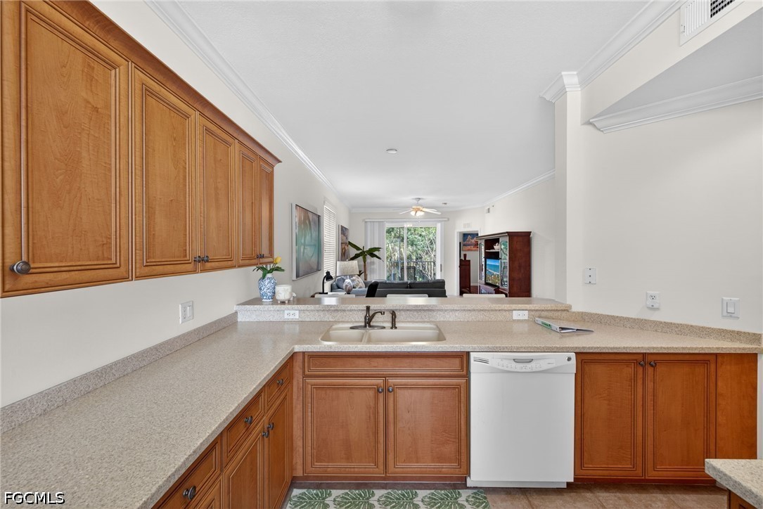 8251 Pathfinder Loop, Unit 621 Fort Myers, FL 33919 - Photo 4 of 30 a kitchen with granite countertop a sink stainless steel appliances and cabinets