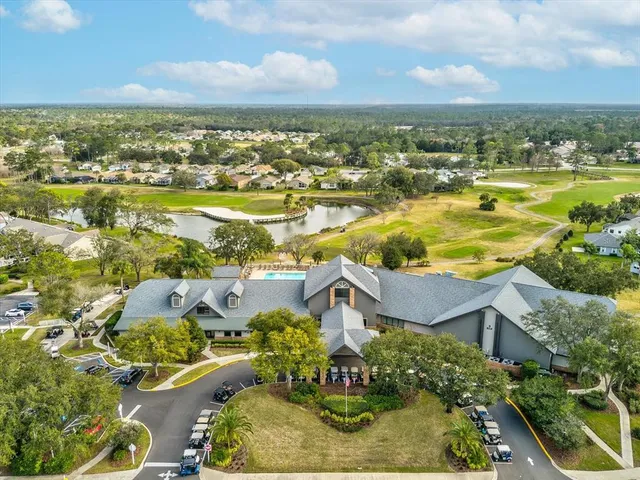 an aerial view of a house with a garden and lake view