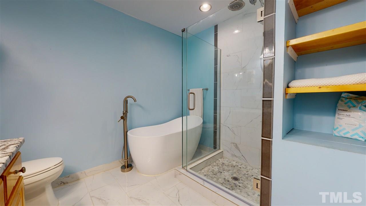 6821 Laurdane Road Raleigh, NC 27613 - Photo 22 of 30 a bathroom with a toilet and a shower