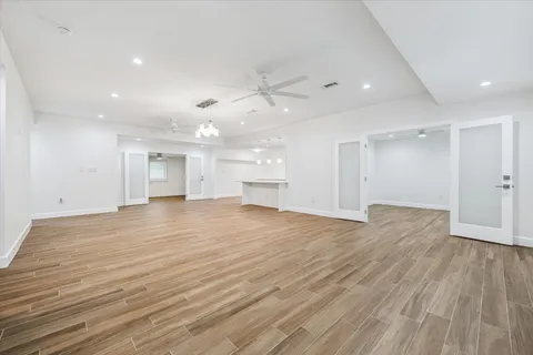 a view of empty room with wooden floor and window