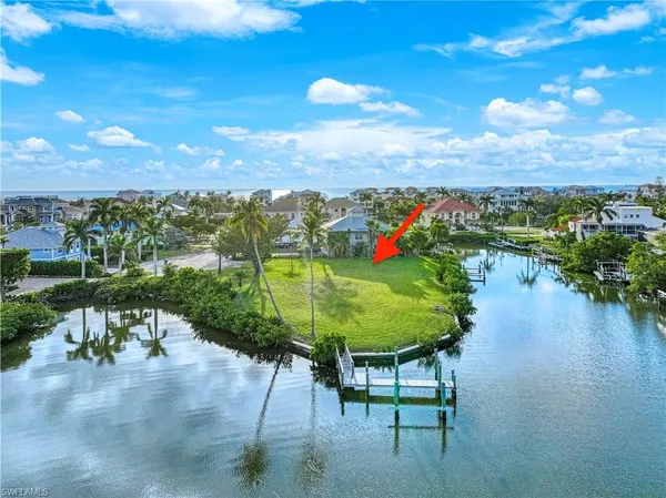 an aerial view of a city with lots of residential buildings lake and ocean view