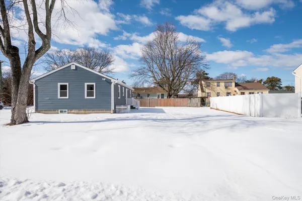 a view of a house with snow on the road