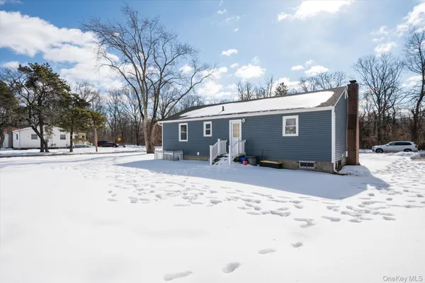 a view of the house with snow on the road