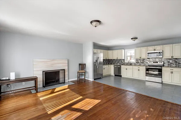 a view of kitchen with microwave and cabinets
